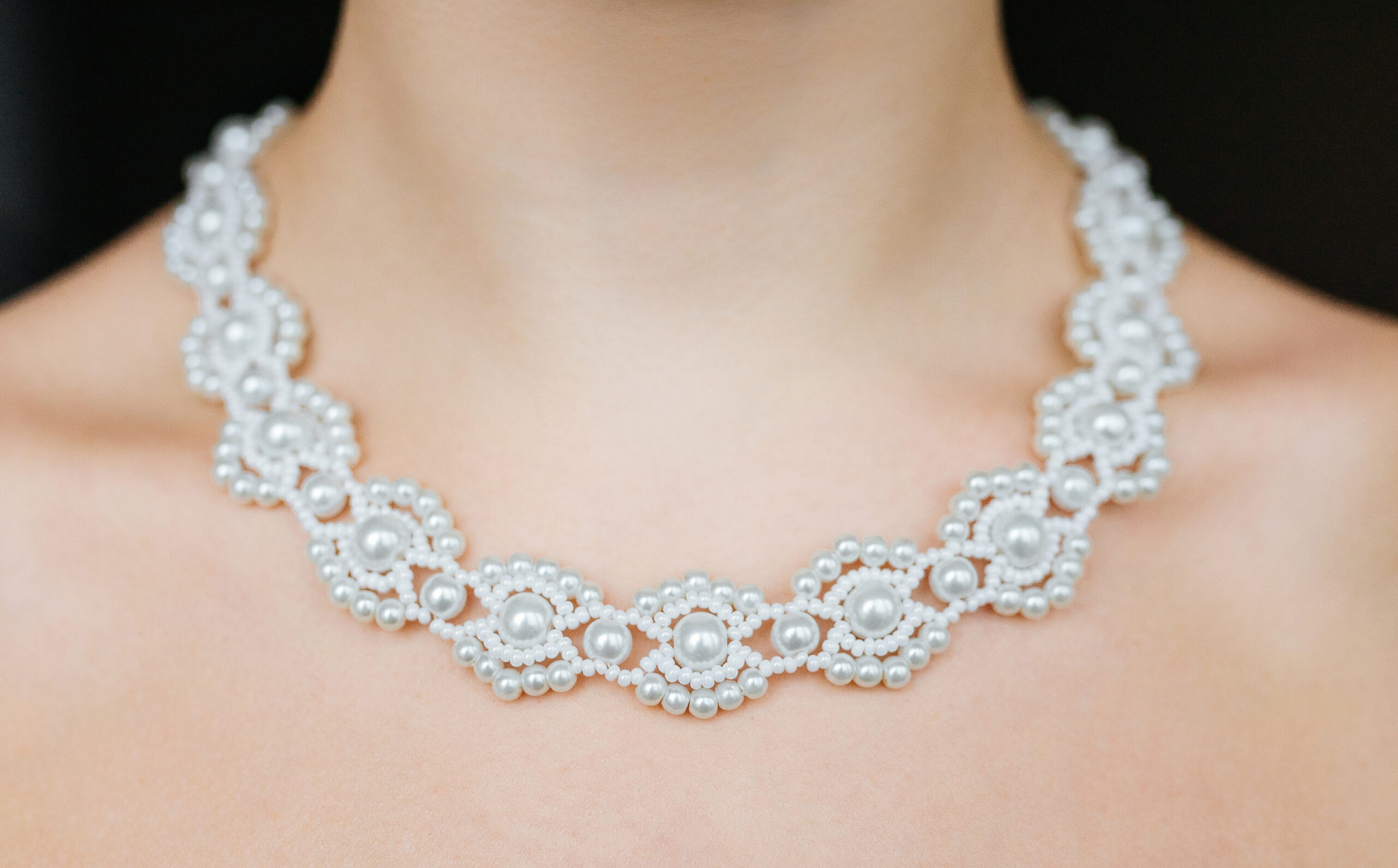 Jewelry concept. Closeup portrait of a wedding necklace on female neck